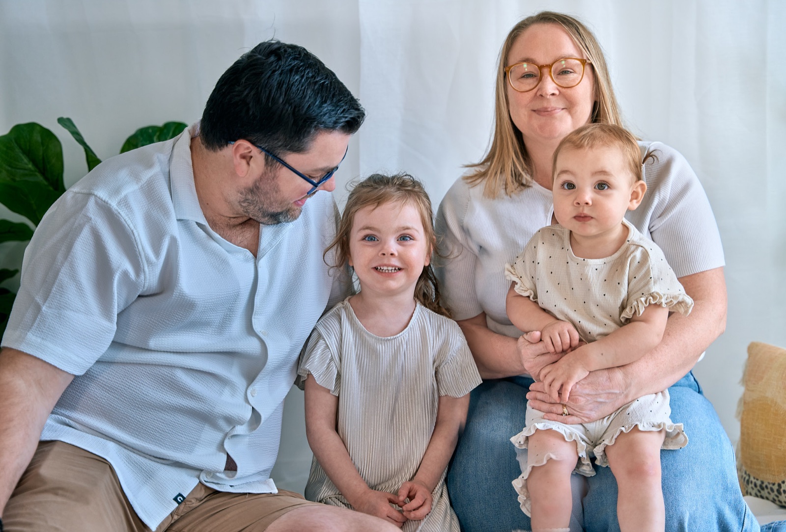 Dad with his two kids among the greenery, outdoor family session