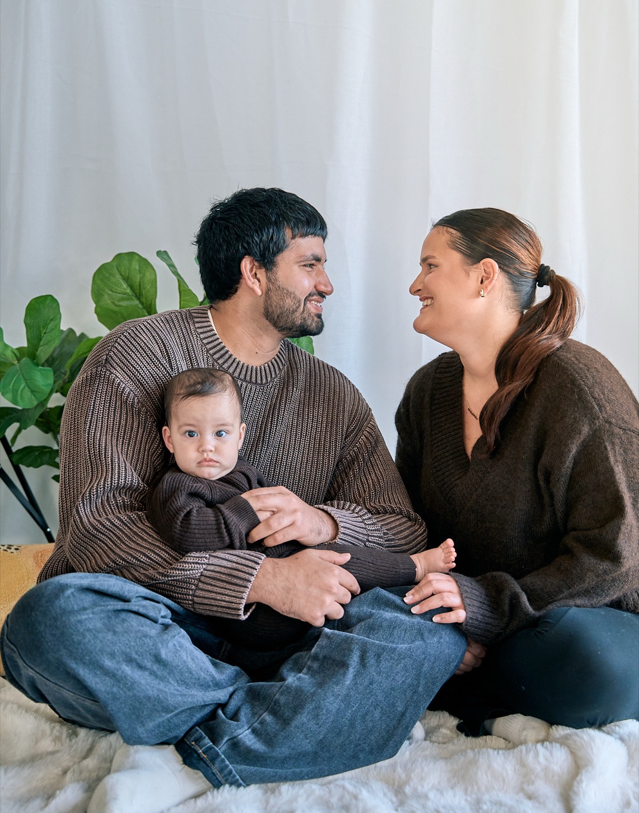 Black and white portrait of a family of four at home