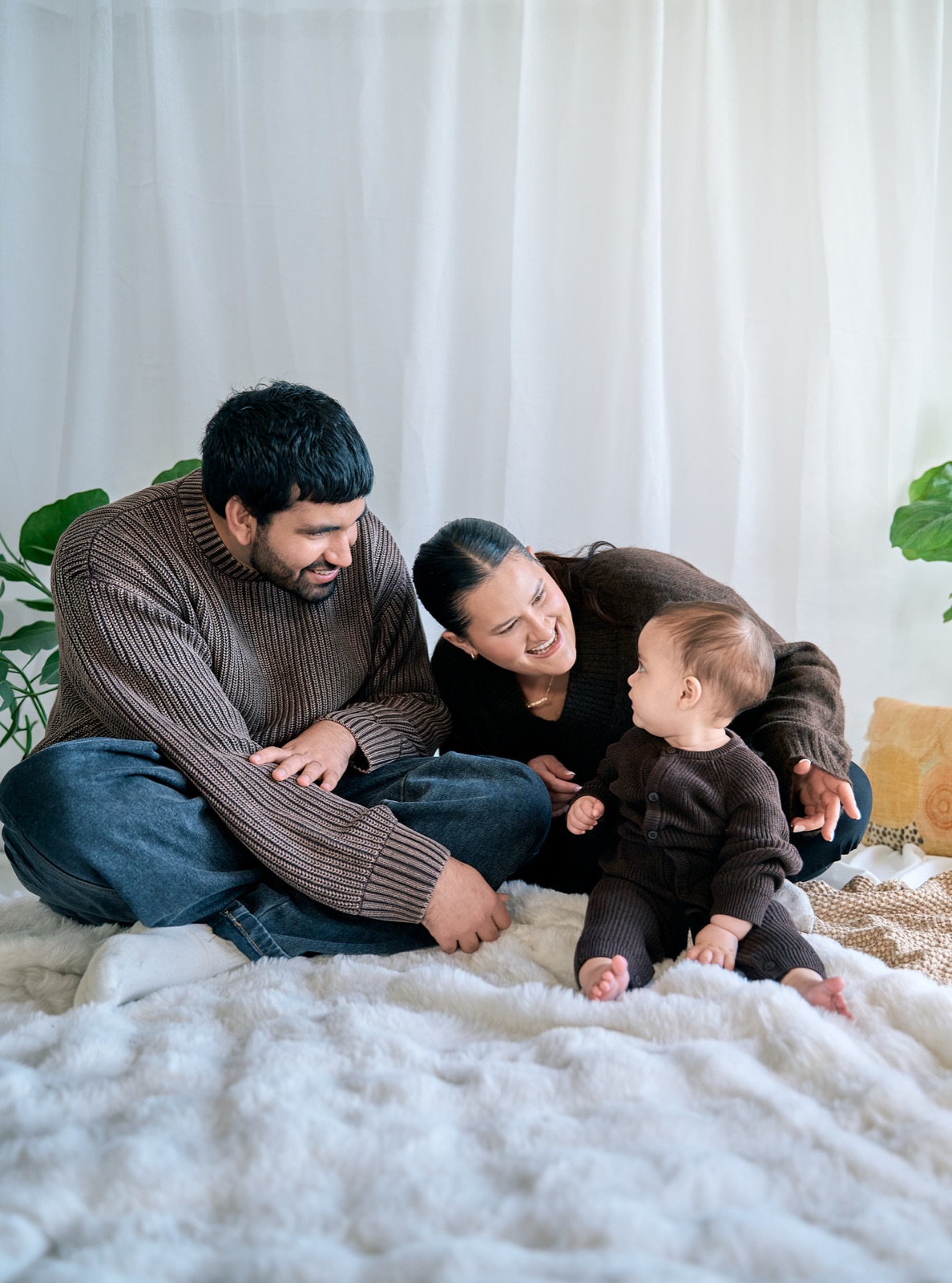 Family of four cuddling on the bed during an in-home session, Seaford