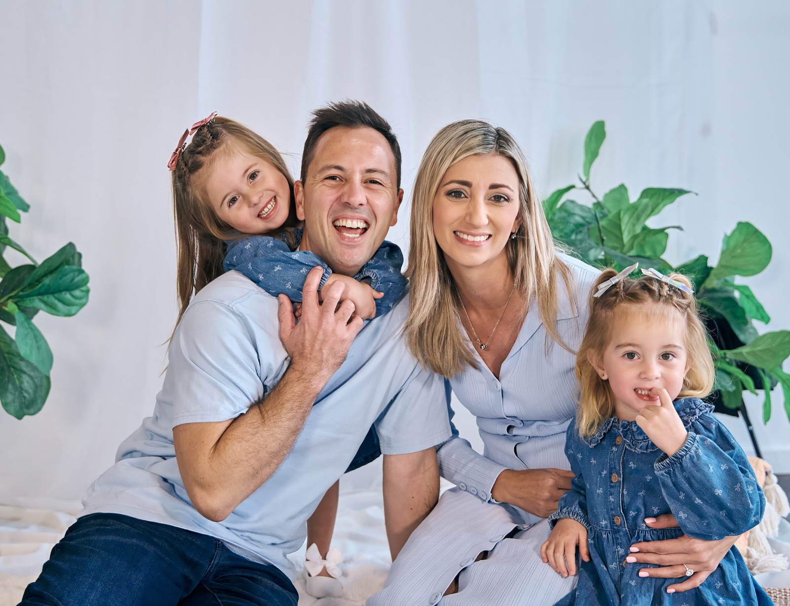 Parents and their two daughters laughing together, family photography Melbourne