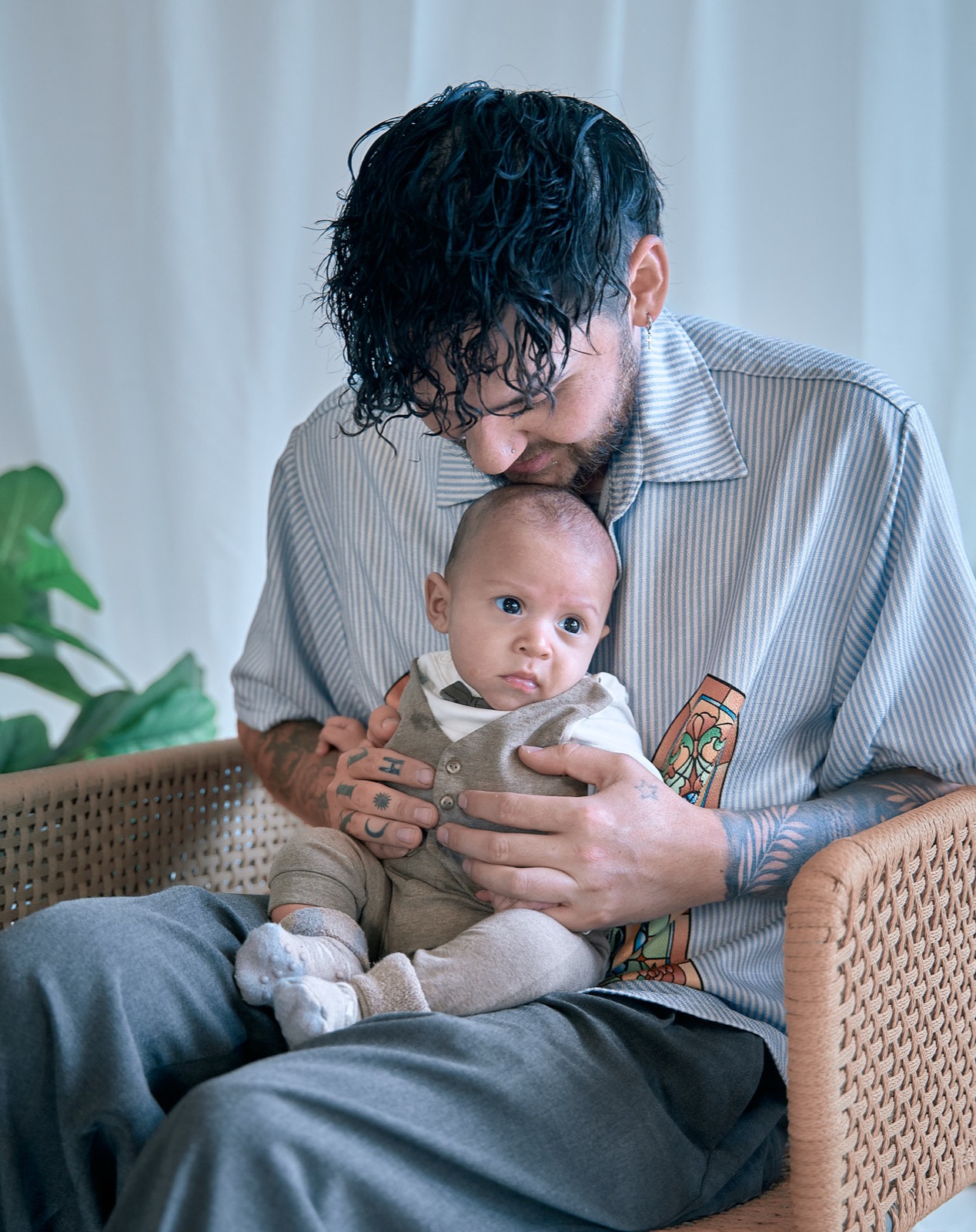 Dad rocking his baby in the nursery chair