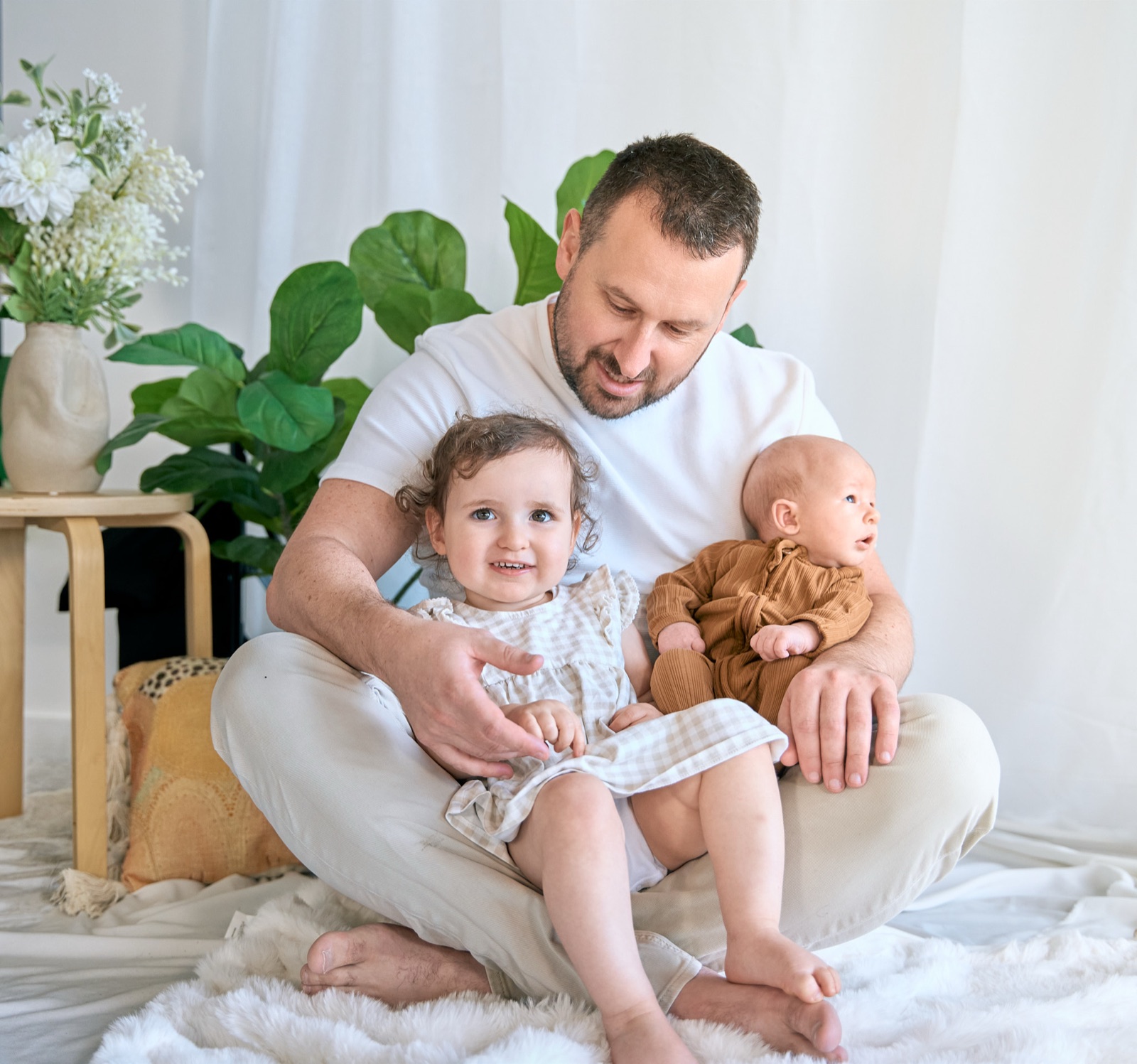 Dad on the floor with his kids and their teddies