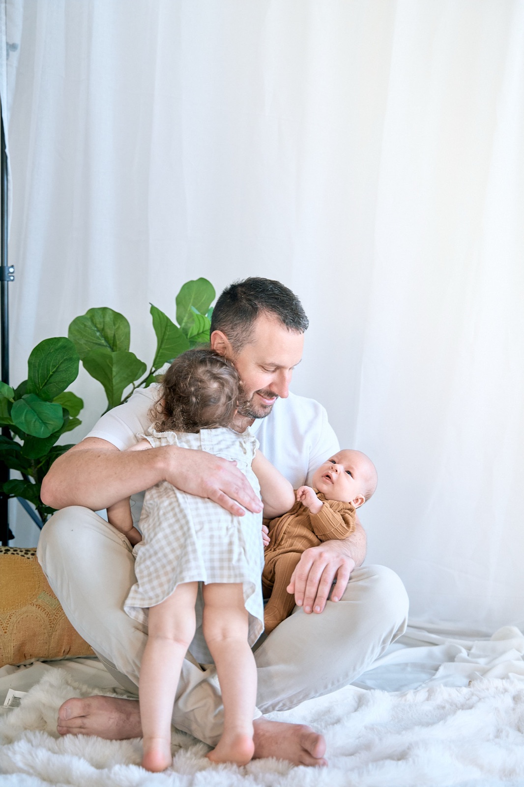Dad hugging his daughter during a bright in-home session