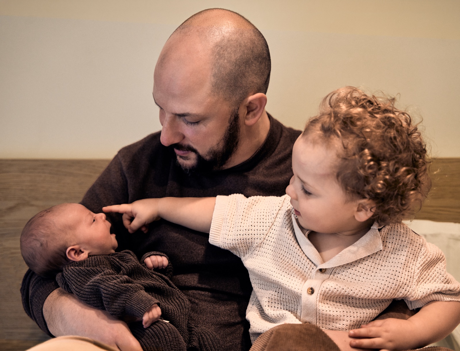 Dad with his toddler in his arms during an in-home newborn session