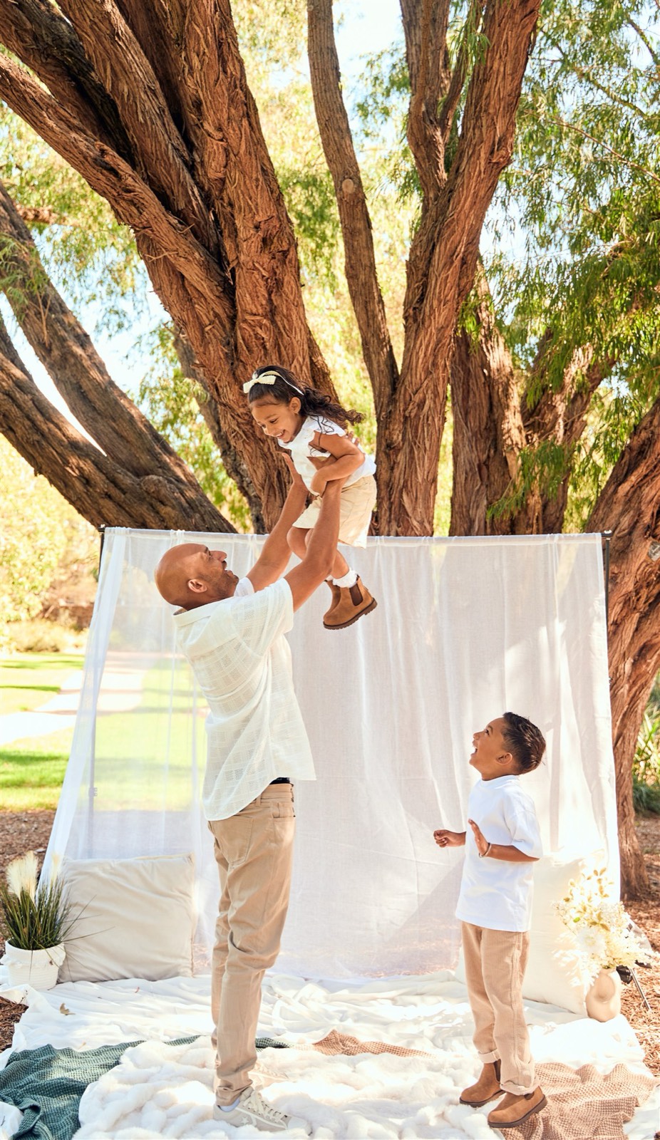 Dad throwing his daughter in the air under the gum trees, outdoor session Frankston