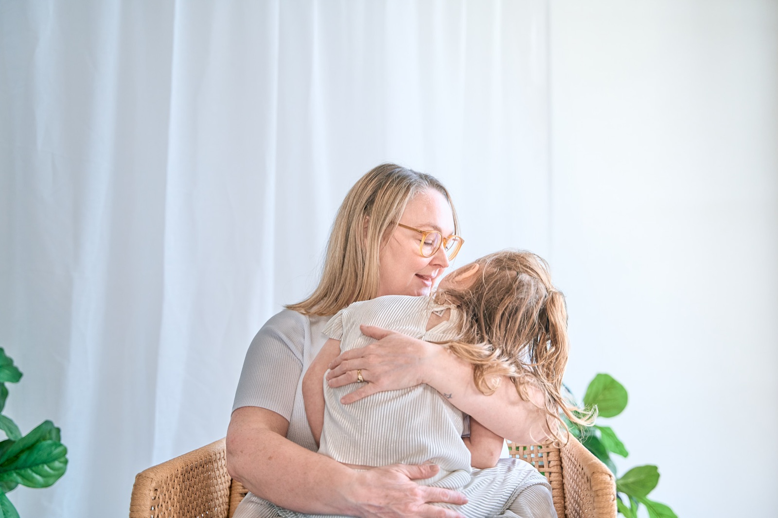 Mum and daughter in a quiet cuddle by the window