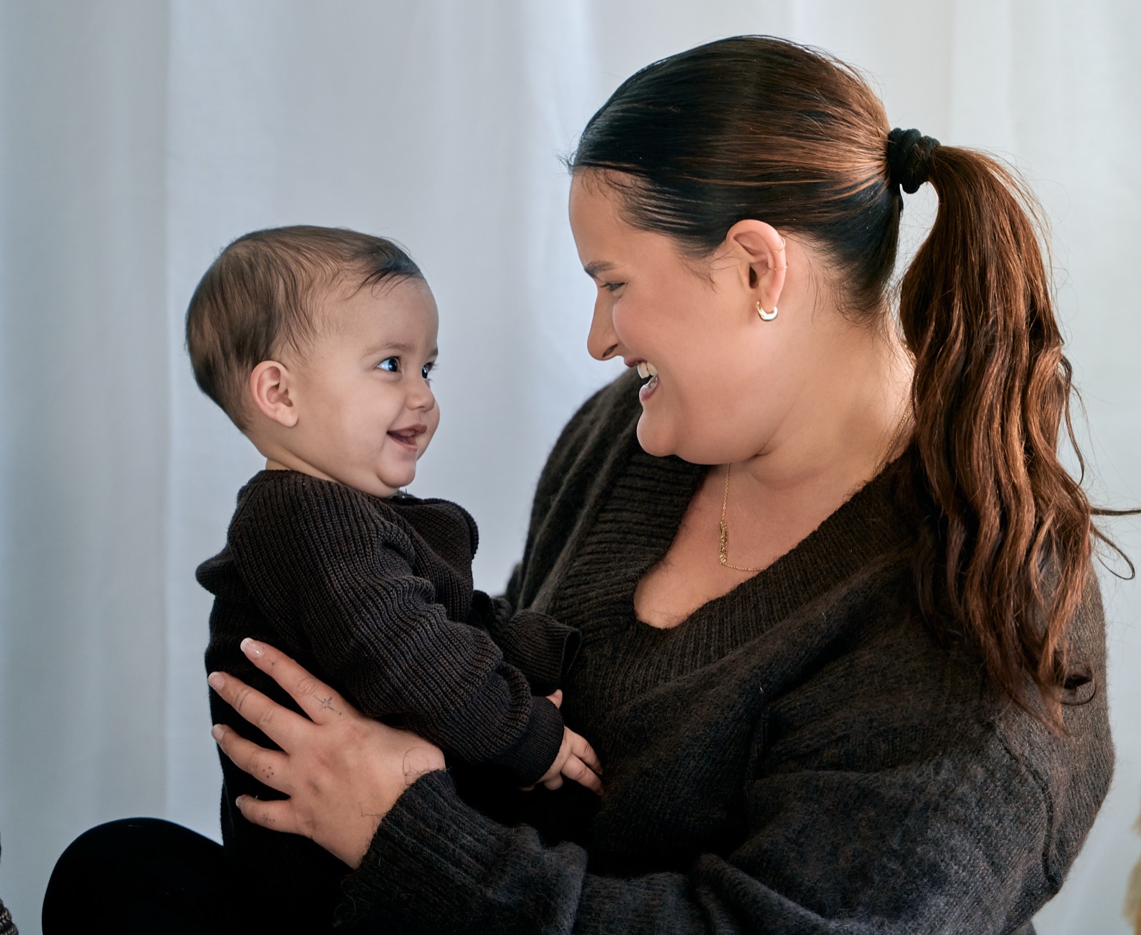 Mum with her toddler on her lap at home