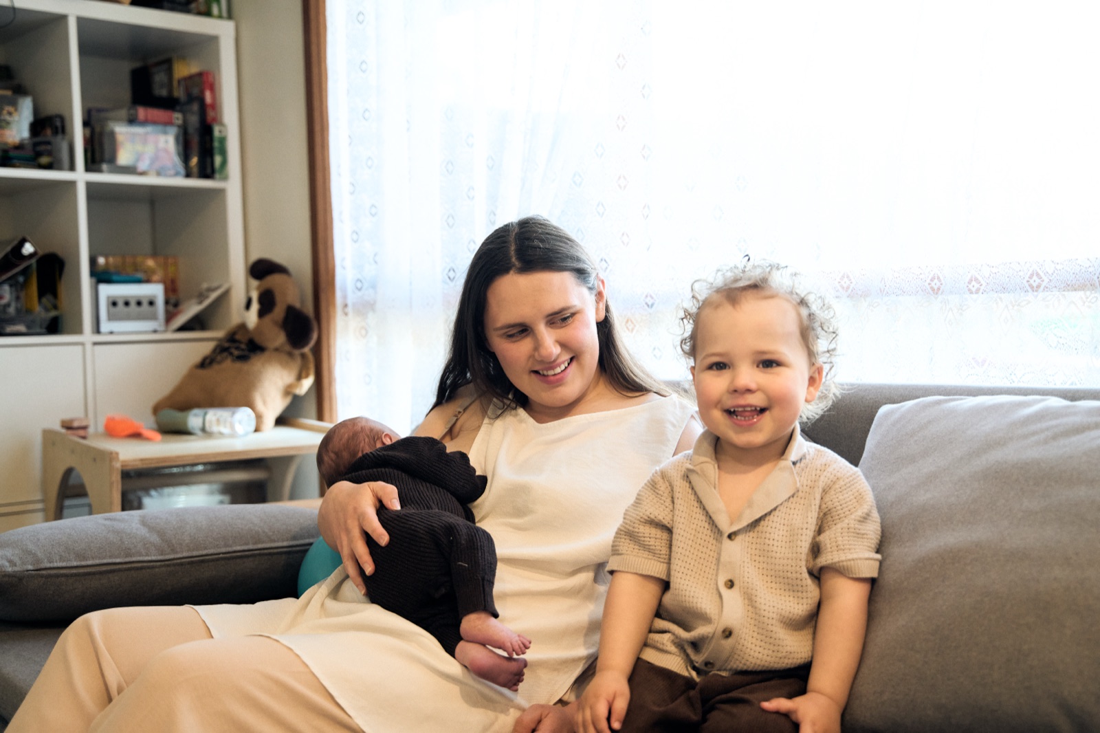 Mum and her two girls on the couch at home