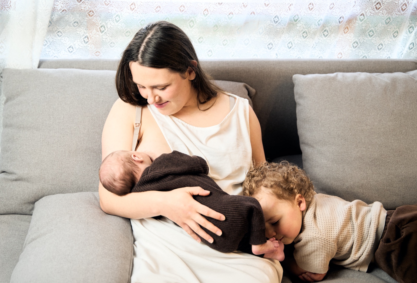 Mum relaxing on the couch with her children, motherhood session