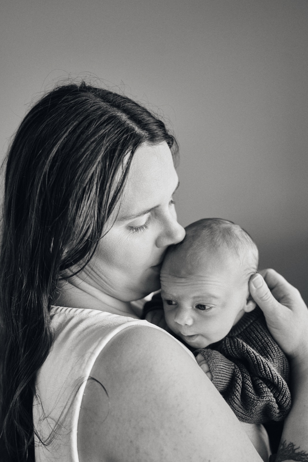 Mum smiling down at the newborn in her arms