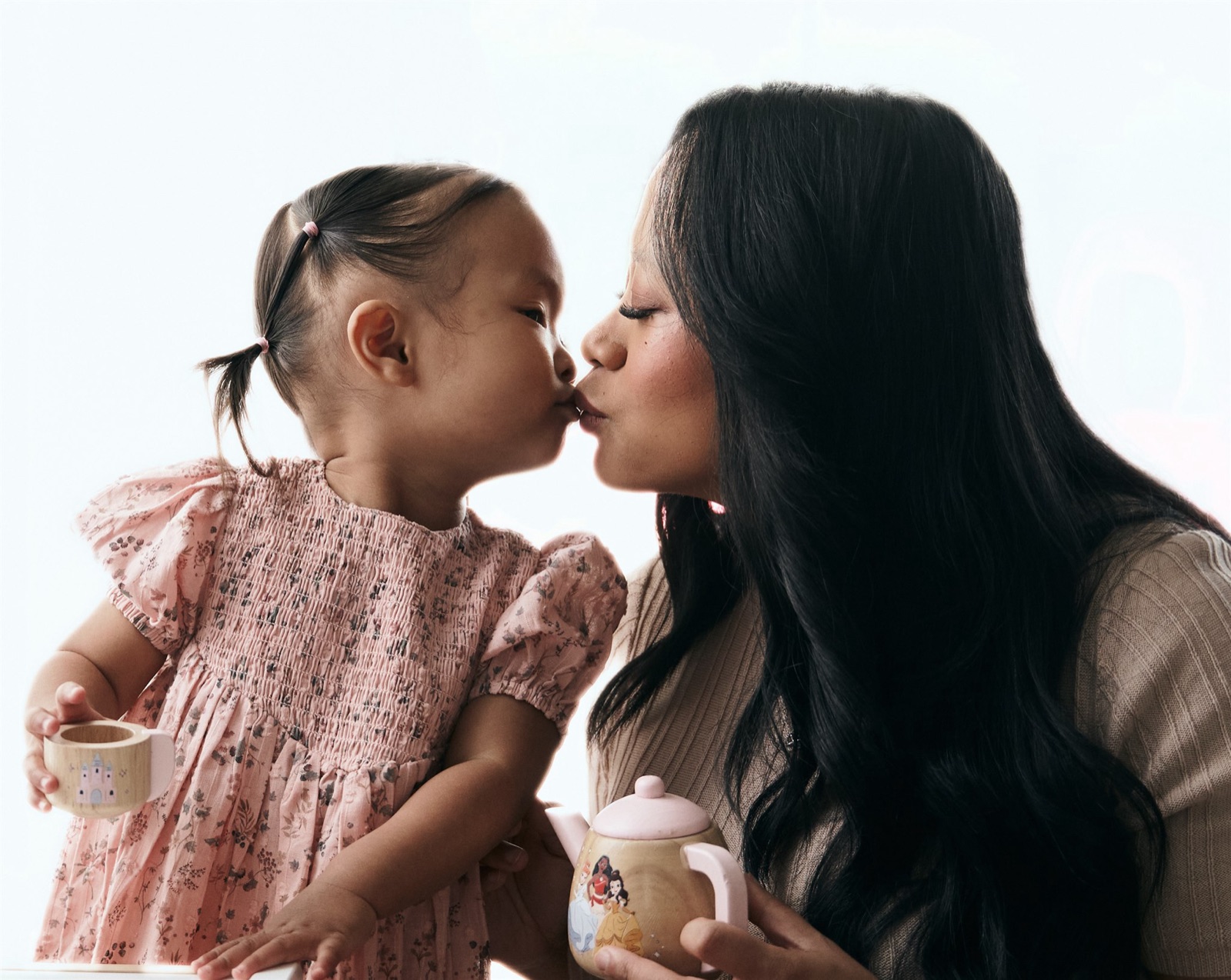 Mum and daughter nose to nose in matching floral dresses
