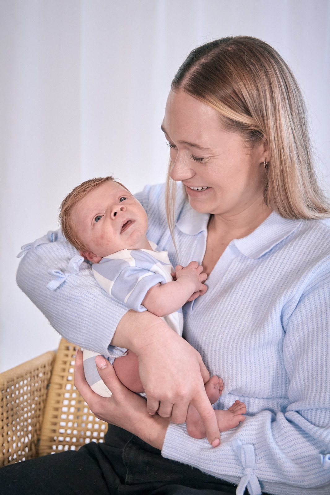 Mum smiling down at her newborn in her arms