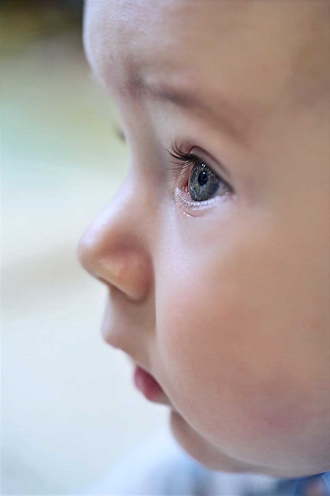 Close-up of a baby's eye and cheek in soft light