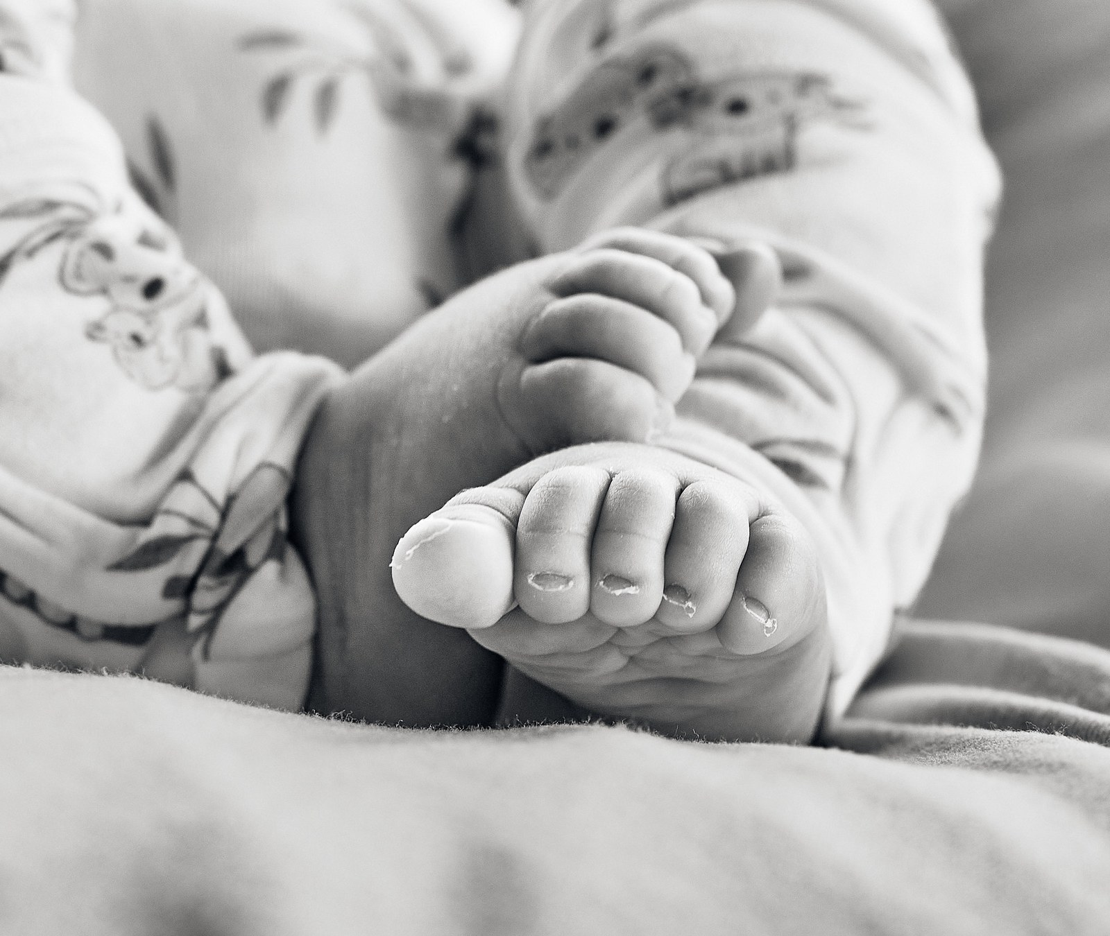 Black and white close-up of a newborn's feet